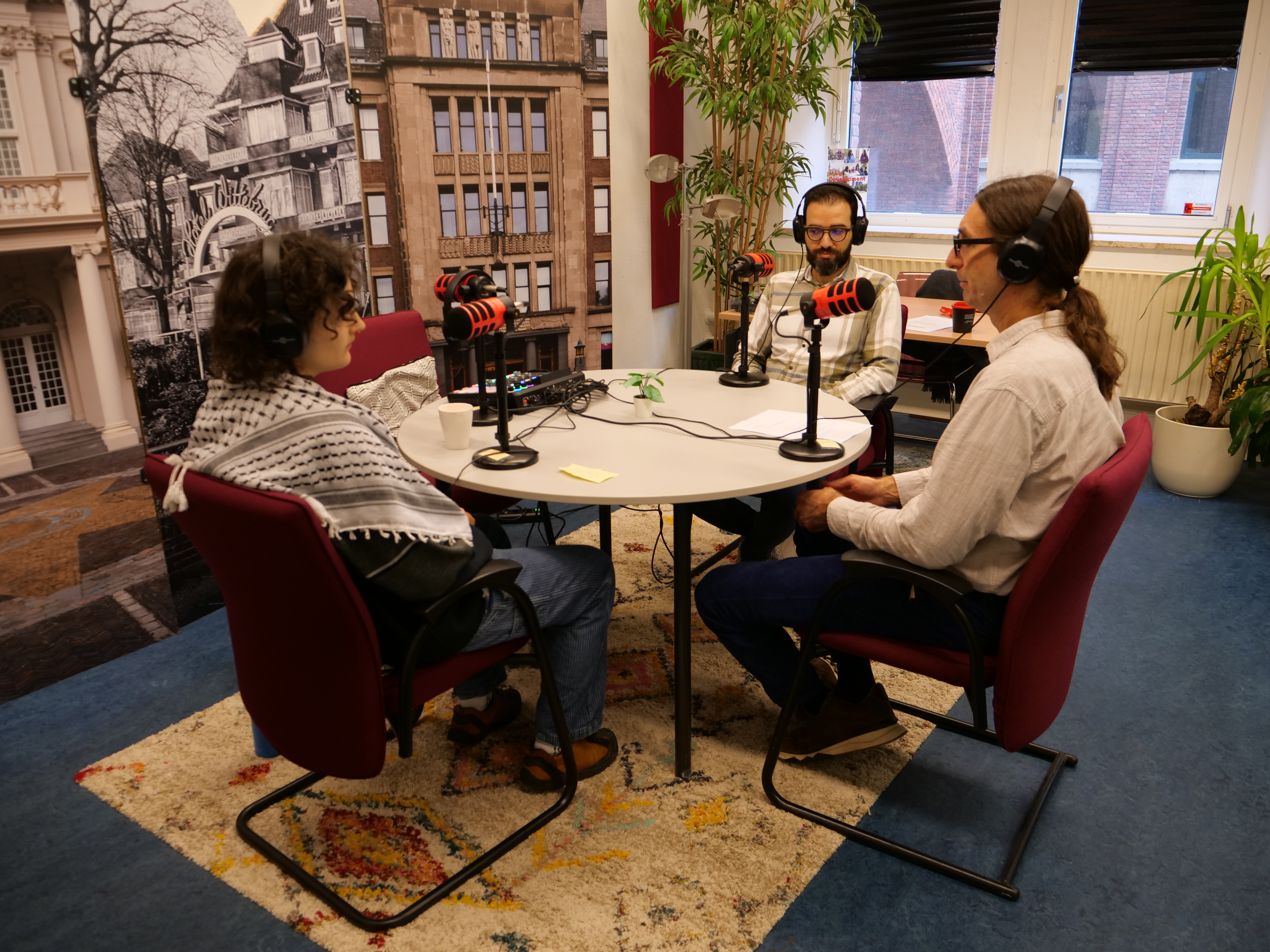 Three speakers around a table